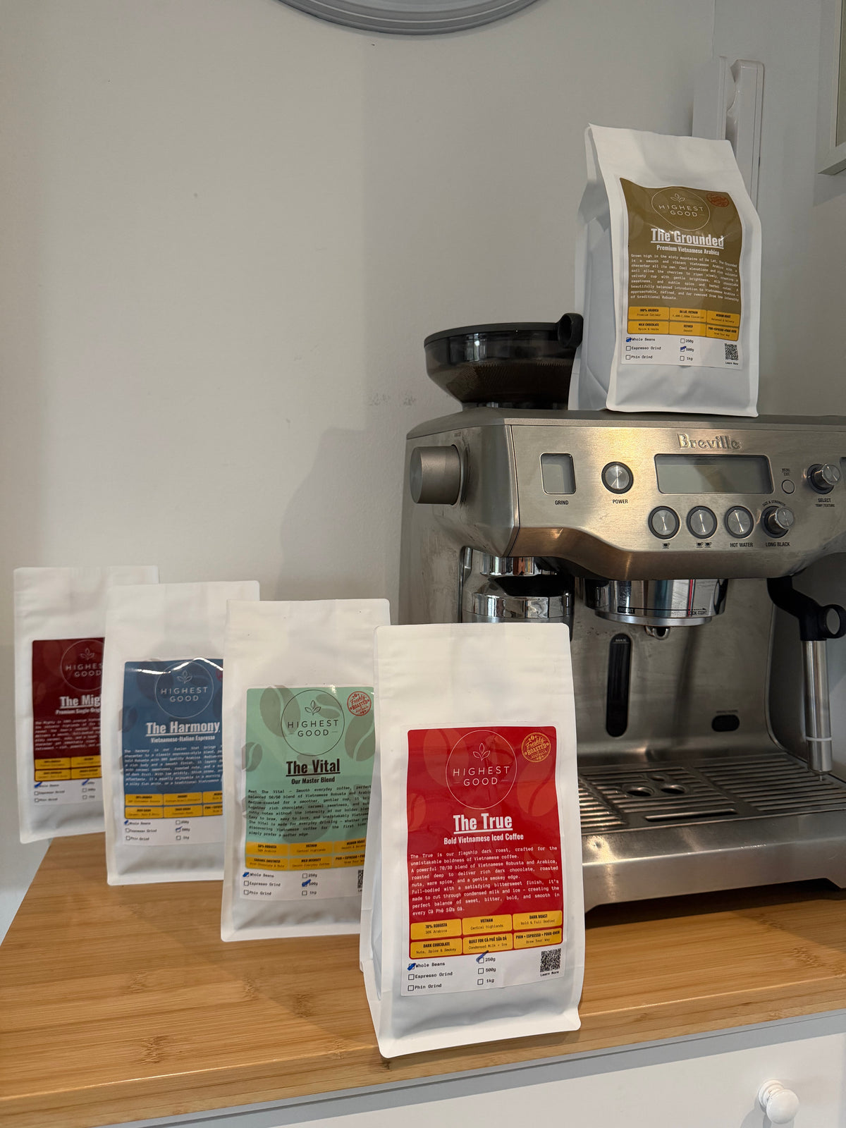Highest Good coffee bags beside a home espresso machine
