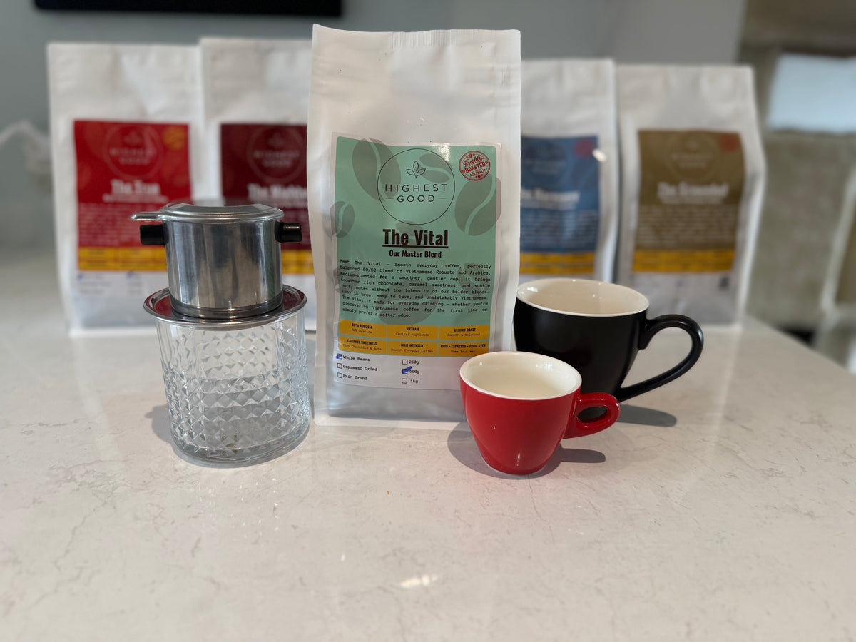 Highest Good The Vital coffee bag in front of the Highest Good range, with a phin filter and cups