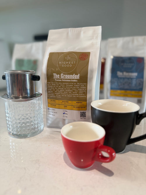 Highest Good The Grounded Vietnamese Arabica coffee bag with a phin filter and espresso cups