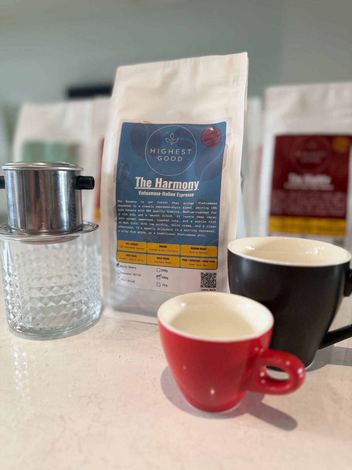 Highest Good The Harmony Vietnamese-Italian espresso blend bag with a phin filter and espresso cups