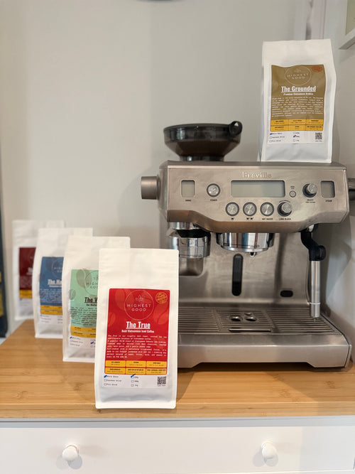 Highest Good coffee bags beside a home espresso machine