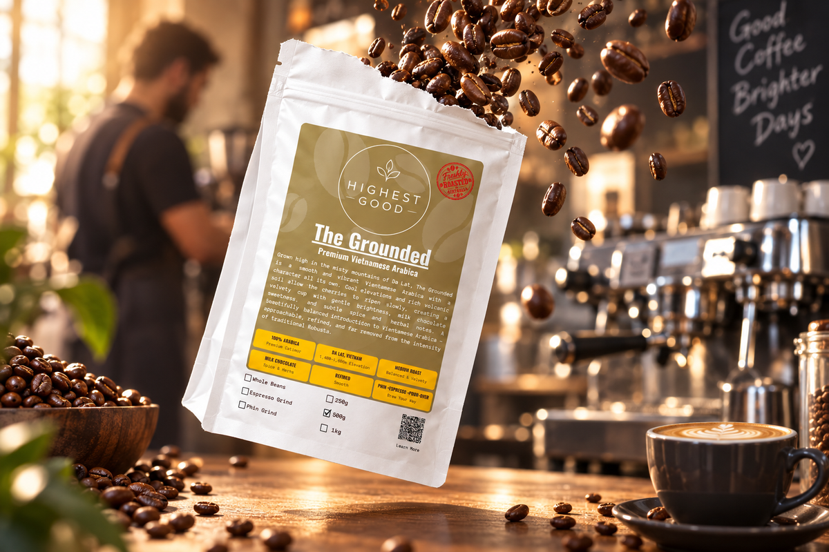 Highest Good The Grounded Vietnamese Arabica coffee pouch with a latte on a coffee bar