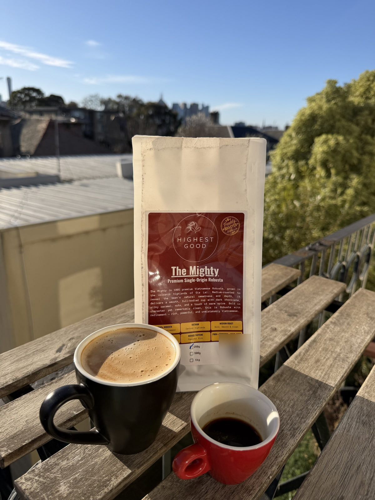 Highest Good The Mighty Vietnamese Robusta coffee beans with a latte and espresso on a sunny balcony
